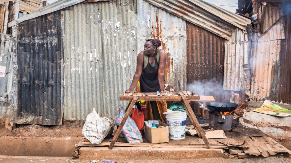 A fried fish vendor displays her products in Kibera slum, Nairobi, Kenya.