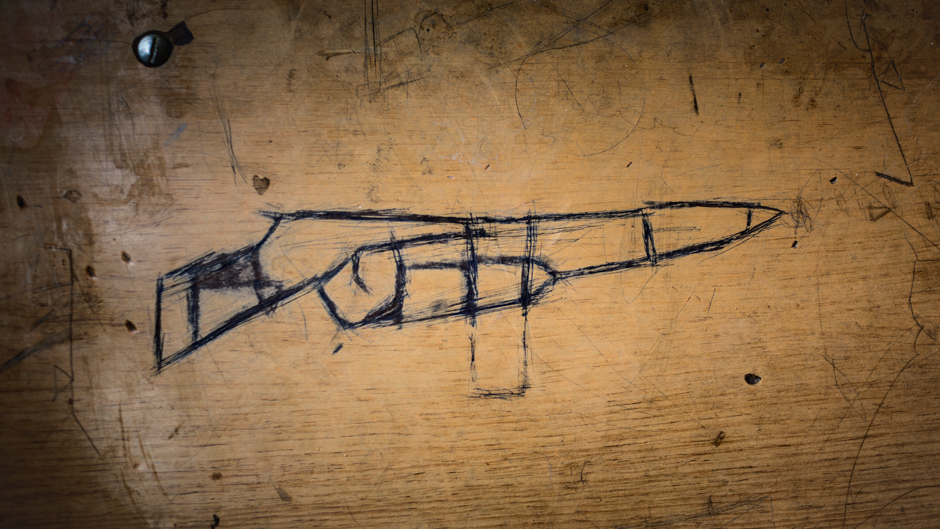 A gun drawn on a school desk in Northern Iraq, 2016. From: Hijacked Education, Diego Ibarra Sánchez