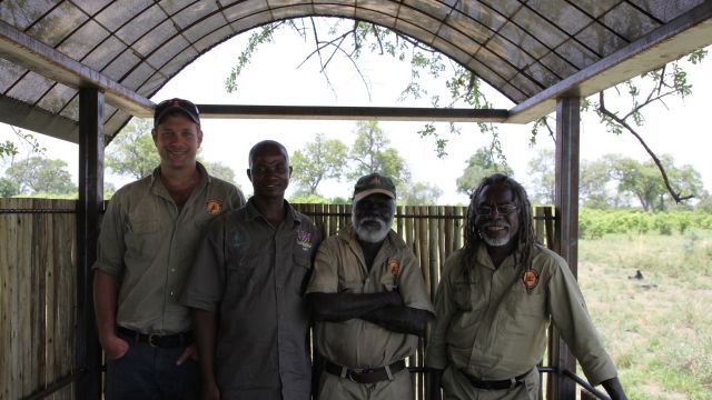 Namibian rangers discuss fire management with indigenous Australian fire ecologists in Nambia. L to R: Shaun Ansell, Wardekken Land Management Australia; Singwanga Matambo, a Namibian Parks Ranger; Nigel Gellar, Wardekken; Dean Yibarbuk, Wardekken. Photo: UNU